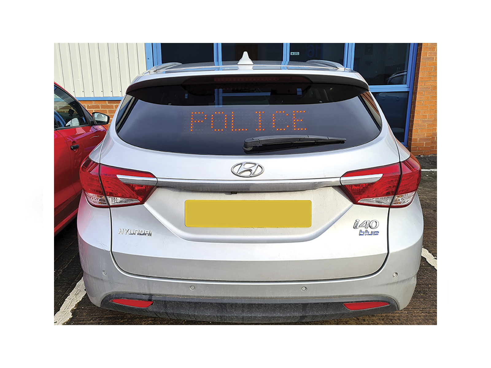 Traffic Commander - Programmable LED Matrix Display In Situ in Back Window of Silver Hyundai Showing Police Message
