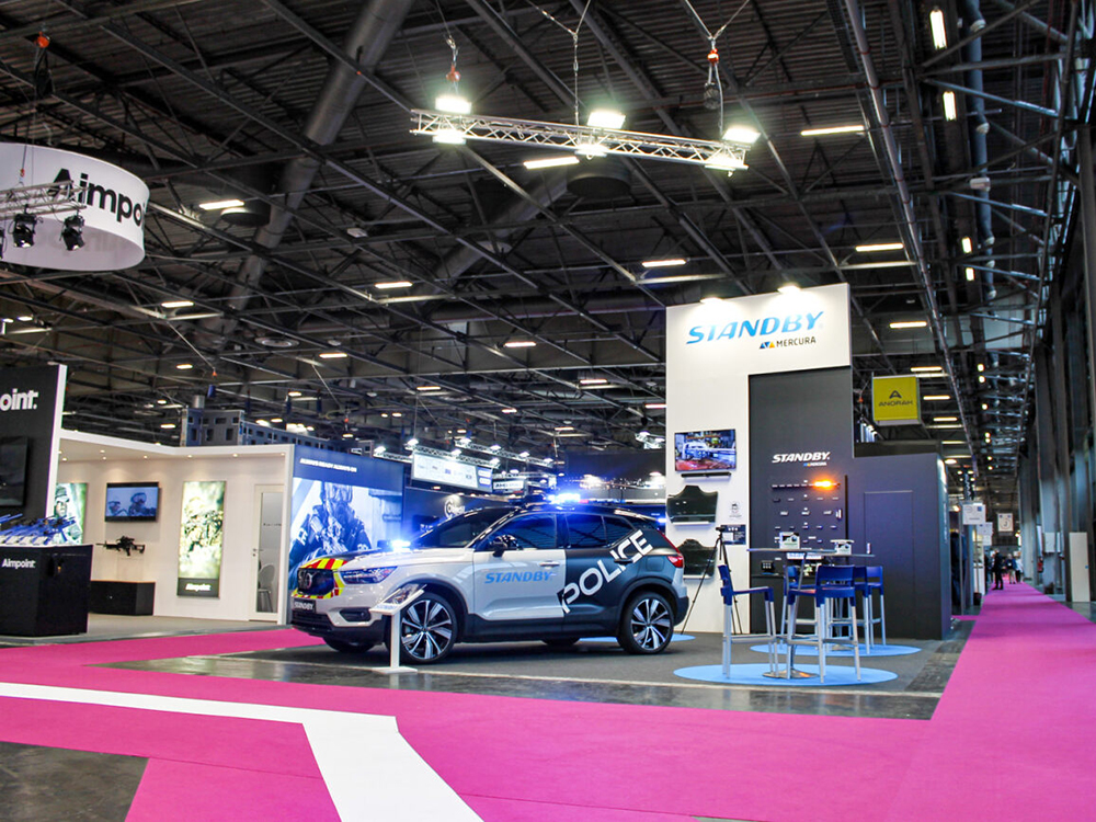 Standby Mercura stand with no people prior to show, far away view. Various products and police car in shot.