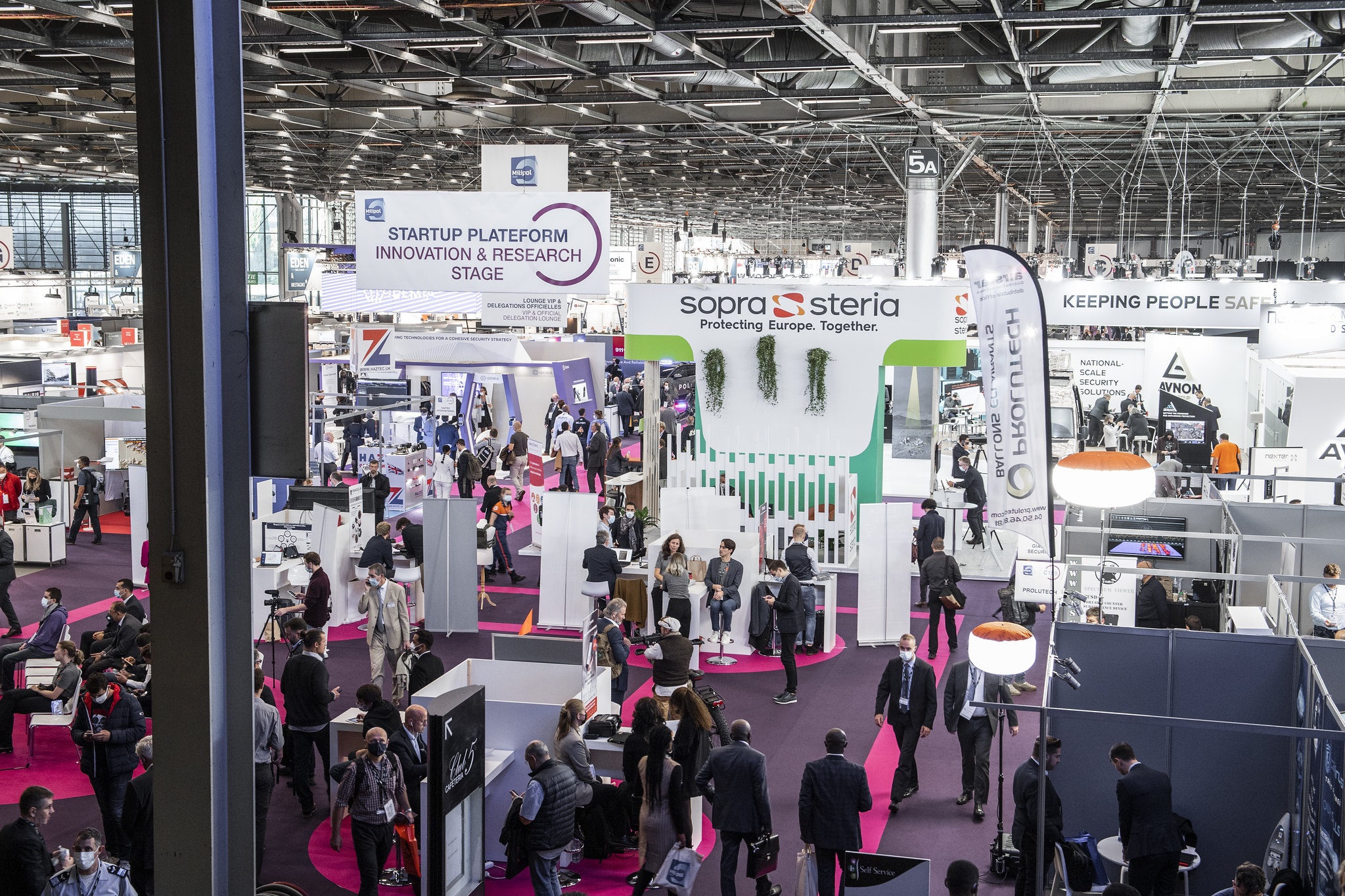 Massa människor inne i en mässhall.